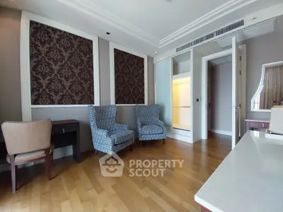 Elegant living room with stylish chairs and wooden flooring in a modern apartment.
