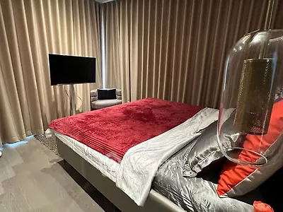 Luxurious bedroom with plush red bedding and modern decor