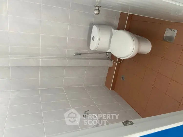 Modern bathroom with white tiles and sleek toilet design