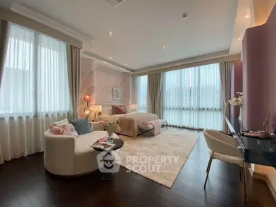 Luxurious bedroom with elegant decor and large windows offering ample natural light.