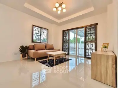 Modern living room with elegant sofa and stylish lighting, featuring large windows and sleek flooring.