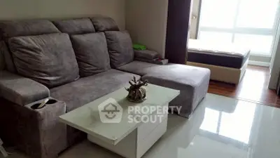 Modern living room with plush gray sofa and sleek marble coffee table
