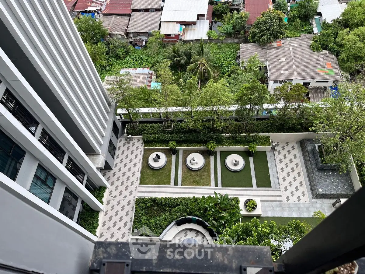 Stunning aerial view of modern building with lush garden and seating area