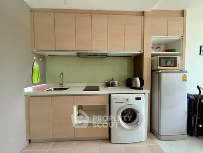 Modern compact kitchen with washing machine and sleek cabinetry
