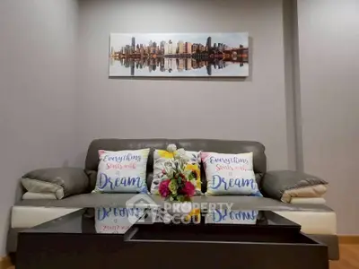 Stylish living room with modern sofa and cityscape artwork, perfect for urban living.