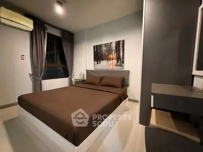 Cozy bedroom with modern decor and large window for natural light