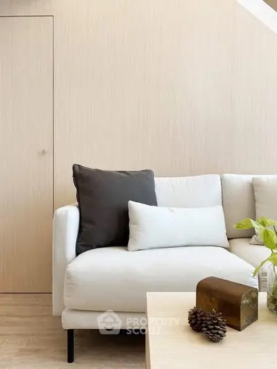 Modern living room with stylish white sofa and minimalist decor