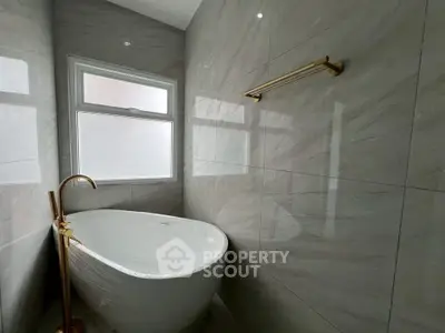 Luxurious bathroom with elegant freestanding bathtub and modern fixtures.