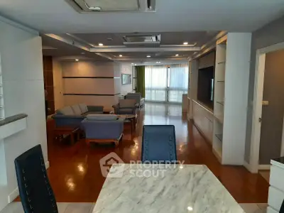Spacious open-plan living room with elegant furnishings and natural light.