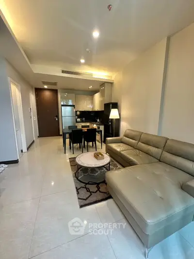 Modern open-layout living room with sleek kitchen and stylish furniture