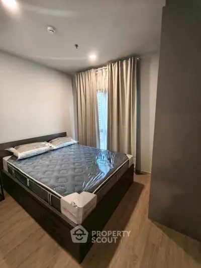 Modern bedroom with sleek design and natural light, featuring a comfortable bed and stylish curtains.