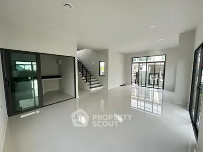 Spacious modern living room with glossy floors and large windows