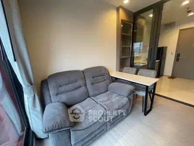 Cozy living room with plush gray sofa and modern decor in a stylish apartment.