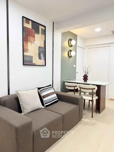 Modern living room with stylish decor and cozy dining area in a contemporary apartment.