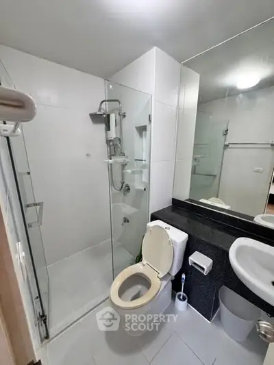 Modern bathroom with glass shower and sleek fixtures