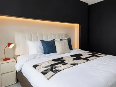 Modern bedroom with stylish decor and ambient lighting, featuring a cozy bed and elegant design.