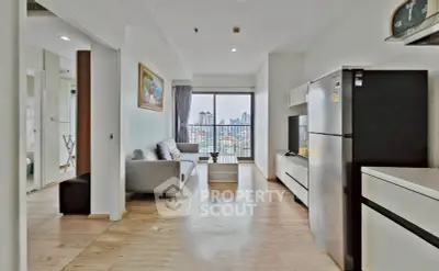 Modern open-plan living room with city view and sleek kitchen appliances.