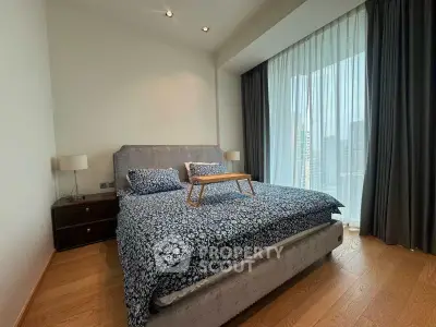 Luxurious bedroom with elegant decor and city view, featuring a cozy bed and stylish furnishings.