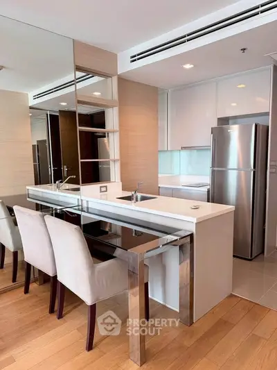 Modern kitchen with sleek design, featuring stainless steel appliances and elegant dining area.