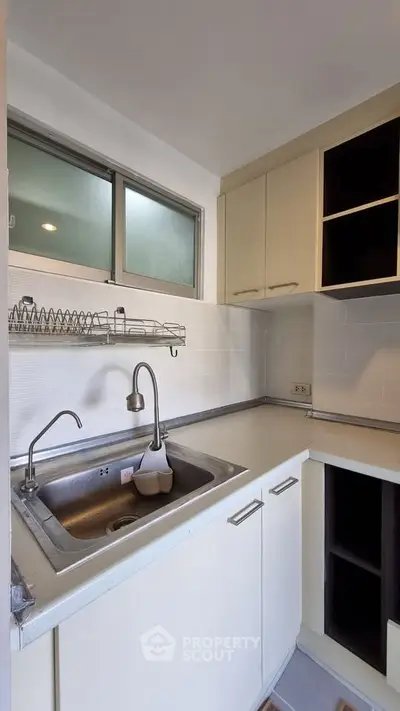 Compact kitchen with modern sink and ample storage space