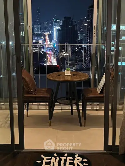 Stunning city view from modern balcony with cozy seating at night