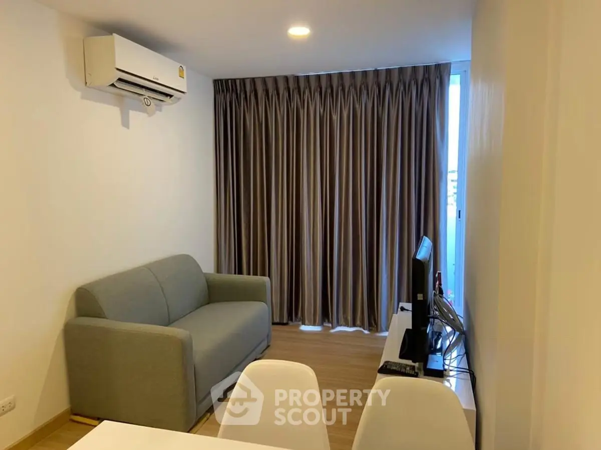 Modern living room with air conditioning and cozy sofa in stylish apartment.