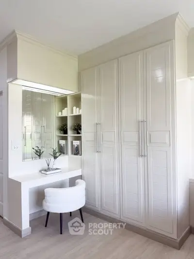 Elegant bedroom with built-in wardrobe and stylish vanity area