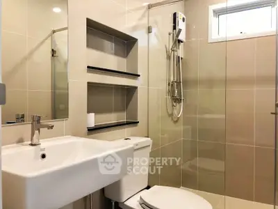Modern bathroom with sleek fixtures and glass shower enclosure