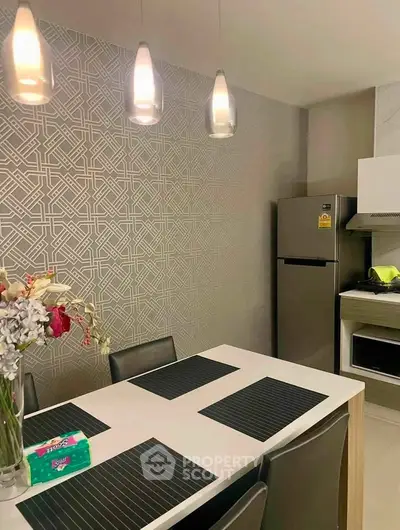 Modern kitchen with sleek dining area and stainless steel appliances