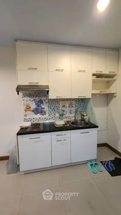 Compact kitchen with modern cabinets and colorful backsplash