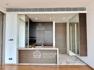 Modern kitchen with sleek cabinetry and built-in oven in a luxury apartment