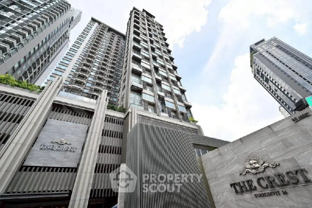 Luxurious high-rise building exterior with modern architectural design in urban setting.
