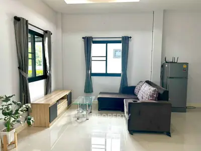 Modern living room with sleek furniture and natural light, featuring a cozy sofa and stylish decor.