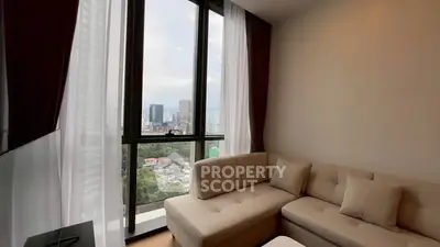 Modern living room with large windows offering stunning city views