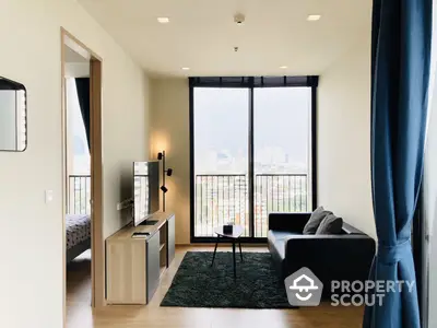 Modern studio apartment with a sleek design, featuring a comfortable living area, large windows with a city view, and a cozy bedroom nook.