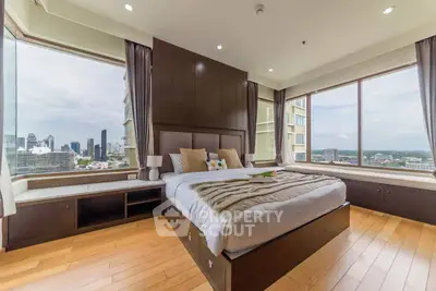 Luxurious bedroom with panoramic city views and elegant wooden flooring
