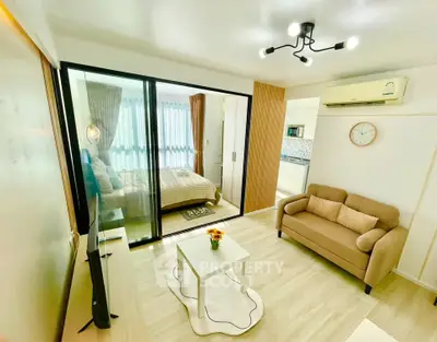 Modern living room with cozy sofa and stylish decor in open layout apartment.