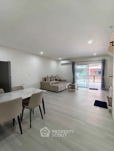 Spacious modern living room with stylish furniture and large windows for natural light.