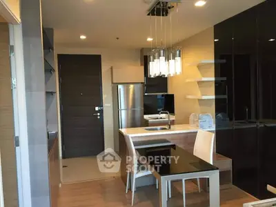 Modern kitchen with sleek design and stainless steel appliances in a stylish apartment.