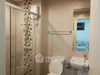Modern bathroom with glass shower and sleek fixtures in a stylish apartment.