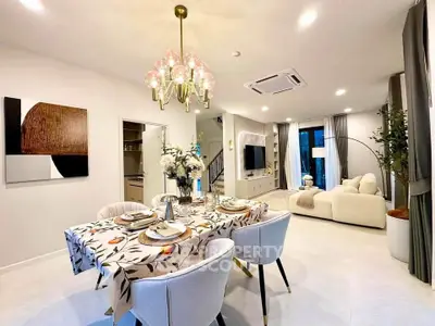 Elegant open-plan living and dining area with modern decor and stylish lighting.