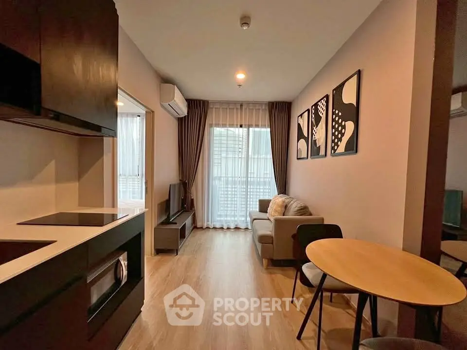 Modern living room with stylish decor and open kitchen layout in a cozy apartment.