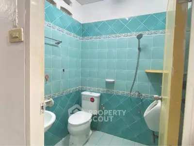 Charming bathroom with turquoise tiles and modern fixtures