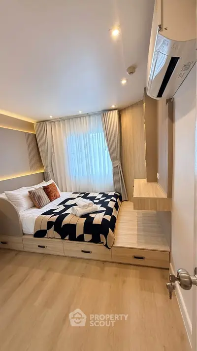 Modern bedroom with stylish decor and built-in storage, featuring cozy lighting and elegant curtains.