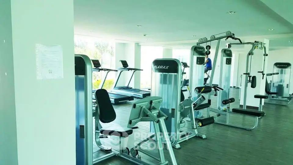 Modern gym with state-of-the-art fitness equipment in a bright, spacious area.