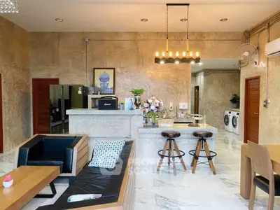 Stylish open-plan living room with modern kitchen and chic decor