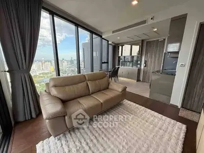Luxurious high-rise living room with panoramic city views and modern furnishings.
