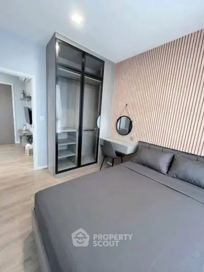 Modern bedroom with sleek design, featuring a stylish wardrobe and cozy bed in a contemporary apartment.