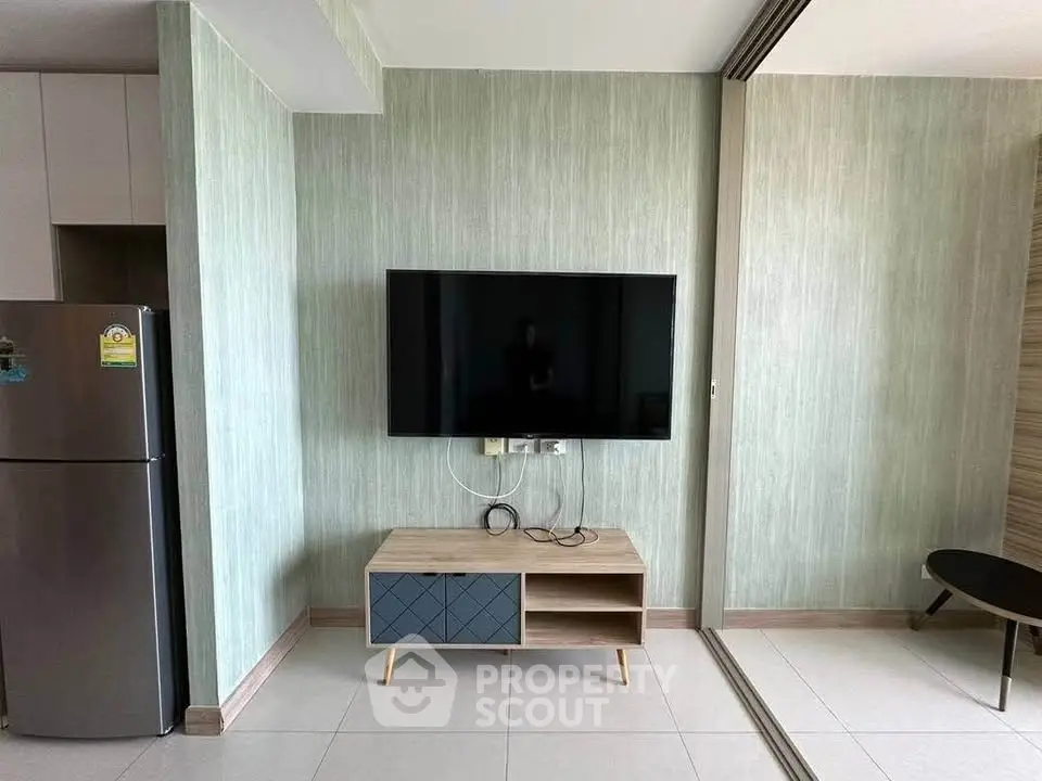 Modern living room with wall-mounted TV and sleek furniture