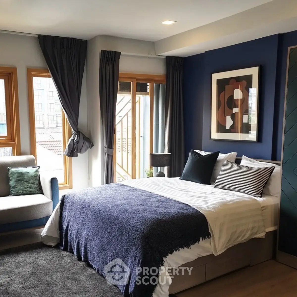 Modern bedroom with stylish decor and large windows for natural light.